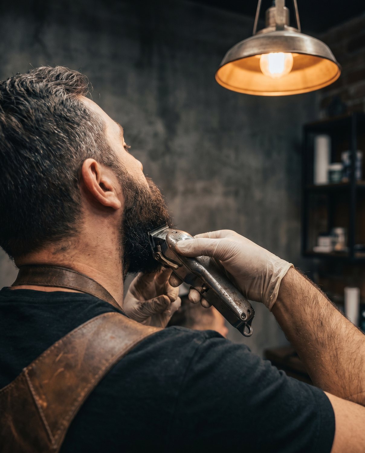 A beard trim in progress, clippers in hand