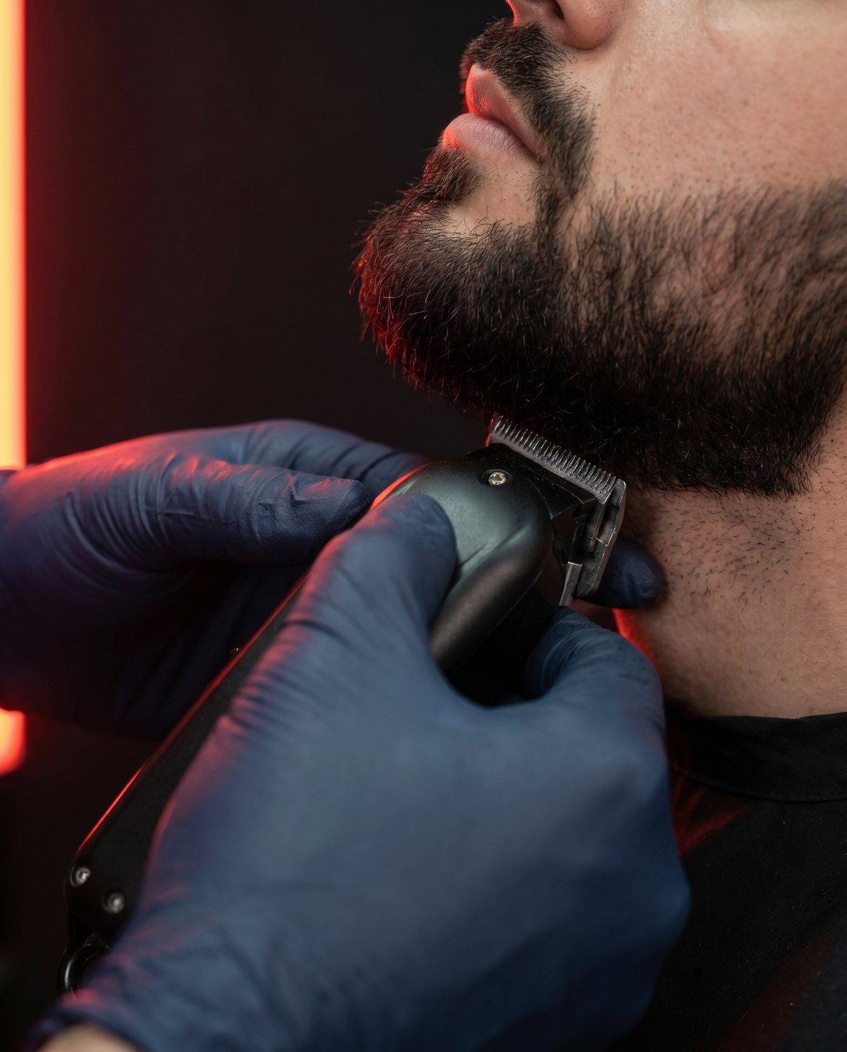 A beard trim in progress with clippers, no face