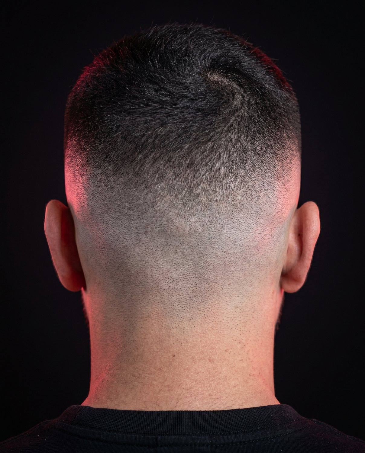 A sharp high skin fade seen from the back of the head