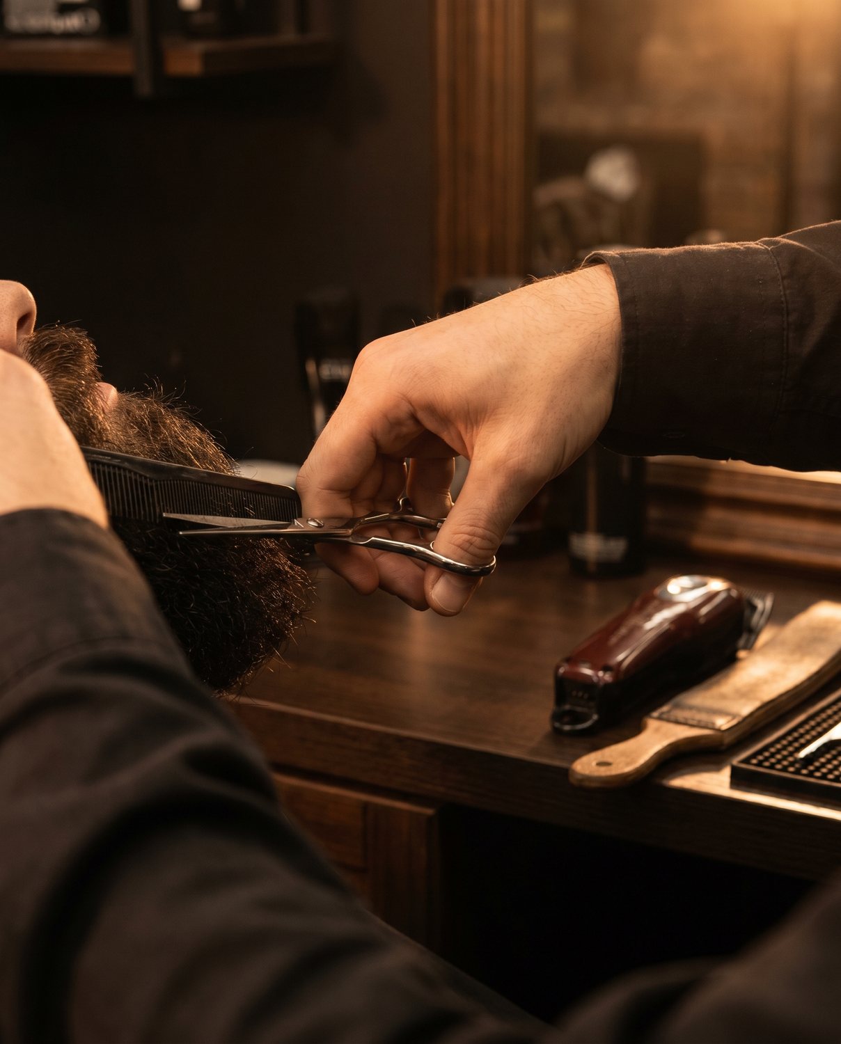 A beard trim in progress with scissors and comb