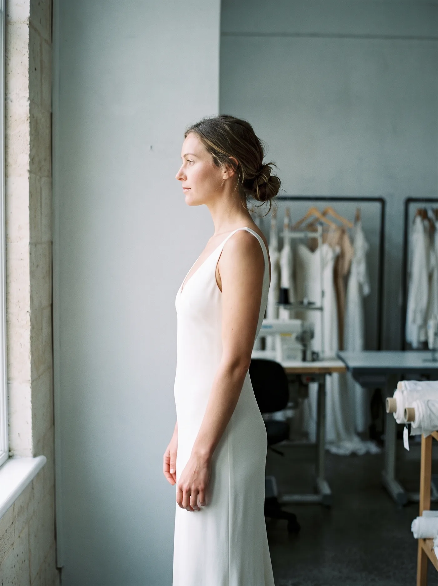 Look 01, a silk column gown photographed in side profile.