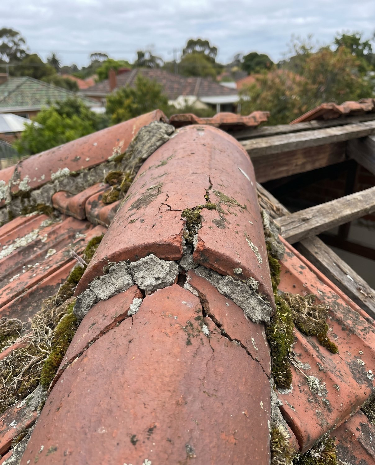 A weathered ridge-cap with failing pointing