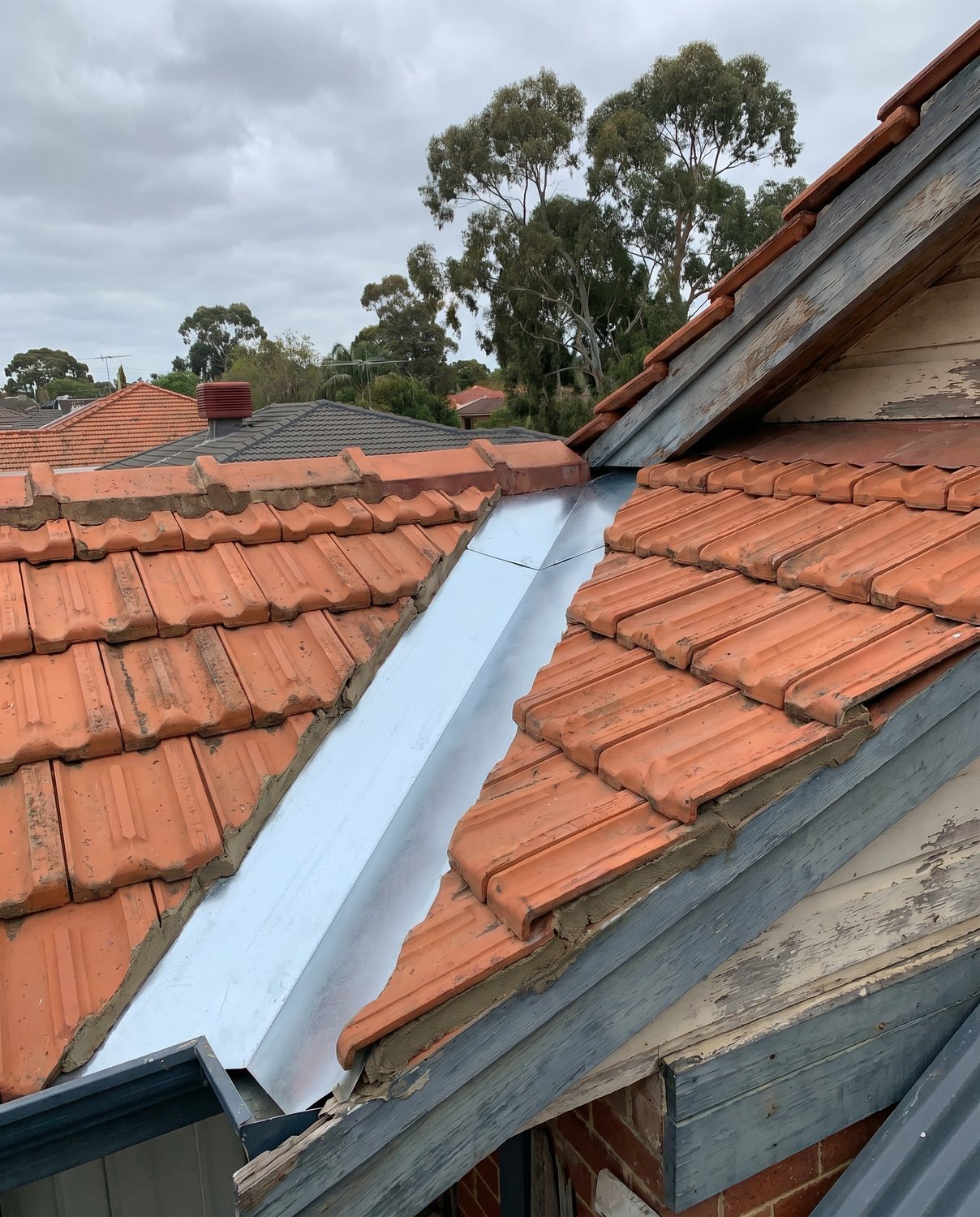 A renewed valley iron on a tile roof